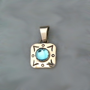 Small square sterling silver pendant with round blue topaz accented with hand stamped design work.