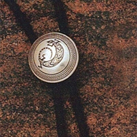 Sterling silver bola tie with Mimbres Lizard design.  One-inch diameter.