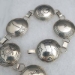 Sterling silver link belt; seventeen 1 1/2 inch pieces with Mimbres designs.