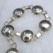 Sterling silver link belt with Mimbres designs; 21 one-inch pieces.