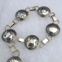 Sterling silver link belt with Mimbres designs; 21 one-inch pieces.