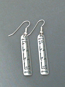 Long strip sterling silver earrings with The Silver Mesa's hand stamped Bird design. 