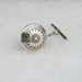 Sterling silver tie tack with Mimbres Sunflower design, 5/8 inch diameter.