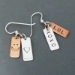 Back view of earrings stamped with a smile and a heart.