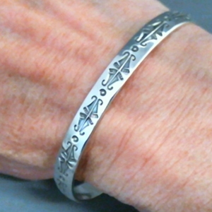 The Silver Mesa's quarter-inch wide sterling silver cuff bracelet-Butterfly design.  Native American made in the USA.