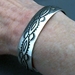 The Silver Mesa's half-inch wide sterling silver cuff bracelet.  Hand stamped Navajo Scallop design.  Native American made.