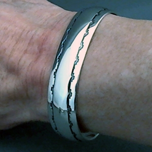 The Silver Mesa's half-inch wide sterling silver cuff bracelet.  Hand stamped Mesa Pueblo design.  Native American made.