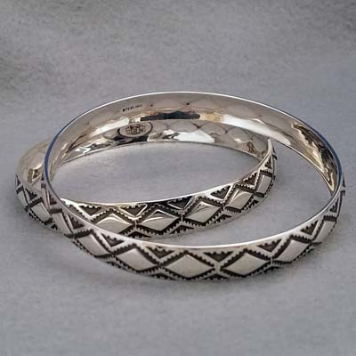 Sterling silver bangle with hand stamped Diamond Back design.  Native American made.