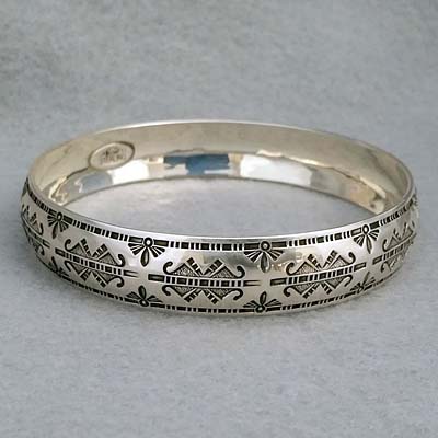 Half-inch wide sterling silver bangle with hand stamped Butterfly design.  Native American made.