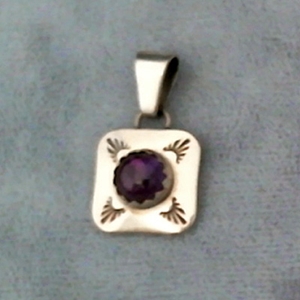 Sterling silver amethyst pendant with hand stamped design work.  Native American made.